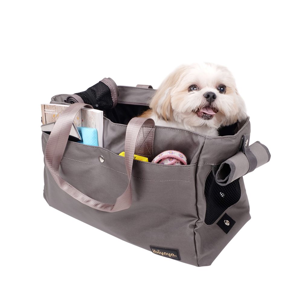 IBIYAYA® Canvas Pet Tote in Army Green carrying a Shih Tzu and miscellaneous items in side pockets